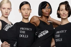 Image A group of women together wearing shirts that say "Protect the dolls."