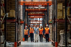 Workers looking in warehouse