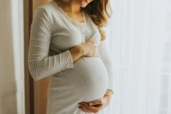 pregnant woman holding her belly