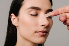 Image woman with bandaid on nose