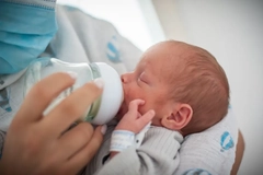 Premature baby drinking from bottle