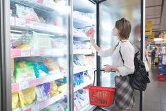 Image Woman shops for frozen food.