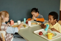 Image Children drink milk from carton packaging