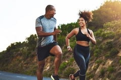 Man and woman running outside