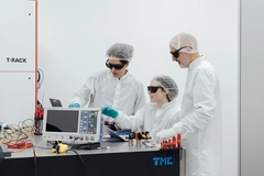 Image three scientists working on a computing device