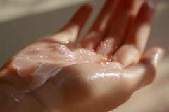 Image Person applying shimmer lotion.