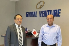 Two men standing in front of a sign