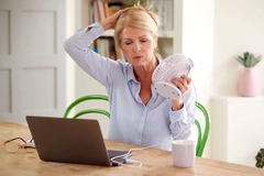 Image menopausal woman having hot flashes