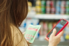 Image A person holding a pack and a phone