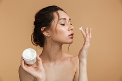 Image Person applying skin cream.