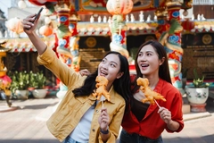 two young asian girls clicking street food photo on mobile two young asian girls clicking street food photo on mobile