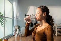 woman drinking water from glas
