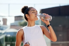 sporty woman drinking functional beverage