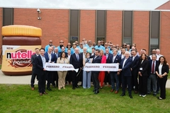 Image corporate group of people in front of large Nutella bottle model