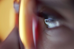 Image closeup of eye looking at a screen