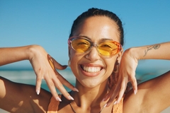 woman smiles in sunglasses
