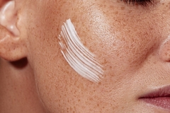 Image Person applying face cream.