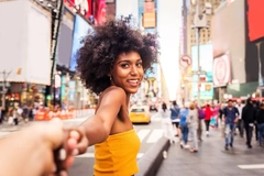 Image A woman in Times Square grabbing someone else's hand.