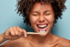 Person brushing teeth.