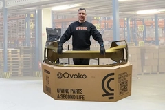 A person standing in a large cardboard box