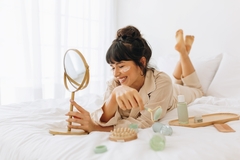 Image Happy woman applying skin care.