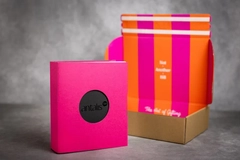 Image A pink packaging with a black circle in it