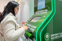 woman using reverse vending machine