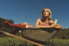 Image campaign photo from Primally Pure, woman sitting in wheelbarrow