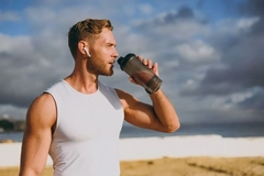 male athlete drinking protein shake