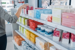 Consumer in store with vitamins and minerals