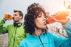 Man and woman drinking sports drink