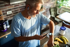 Man checking smartwatch after cooking