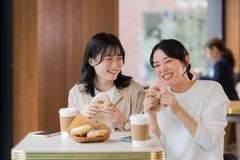 Image Two women happily eating reduced sugar sweets treats.