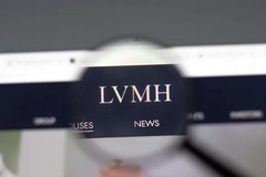 LVMH logo on a computer screen under a magnifying glass