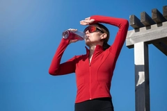 Image sporty woman drinking beverage