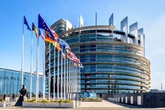 The European Parliament building with flags in front.
