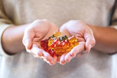 Image Hands holding plant-based gummies.