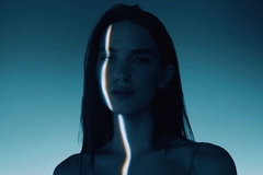 Image image of womans face in dark room, one sliver of light over an eye