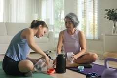 Image Women adding protein powder to shake