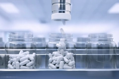 Image Machine filling supplement bottles