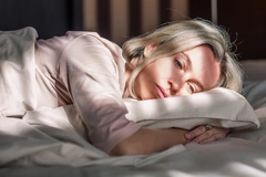 Image Unhappy sad middle aged woman sitting on bed at home
