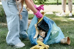 Image A person picking up garbage from a bag