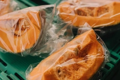 Image A group of cut up pumpkins in transparent bags