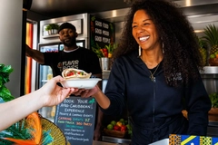 woman hands our food from truck