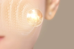 A woman's cheek with a depiction of cells next to it.