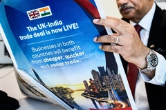 Image Man holding a newspaper with a blue cover page