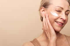Image woman puts cream on cheek