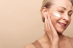 Image woman puts cream on cheek