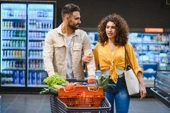 Couple shopping for fruit and vegetables, alternative proteins.