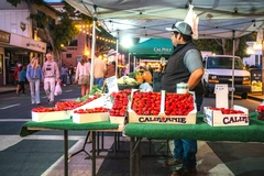 Image market seller standing by his strawberries